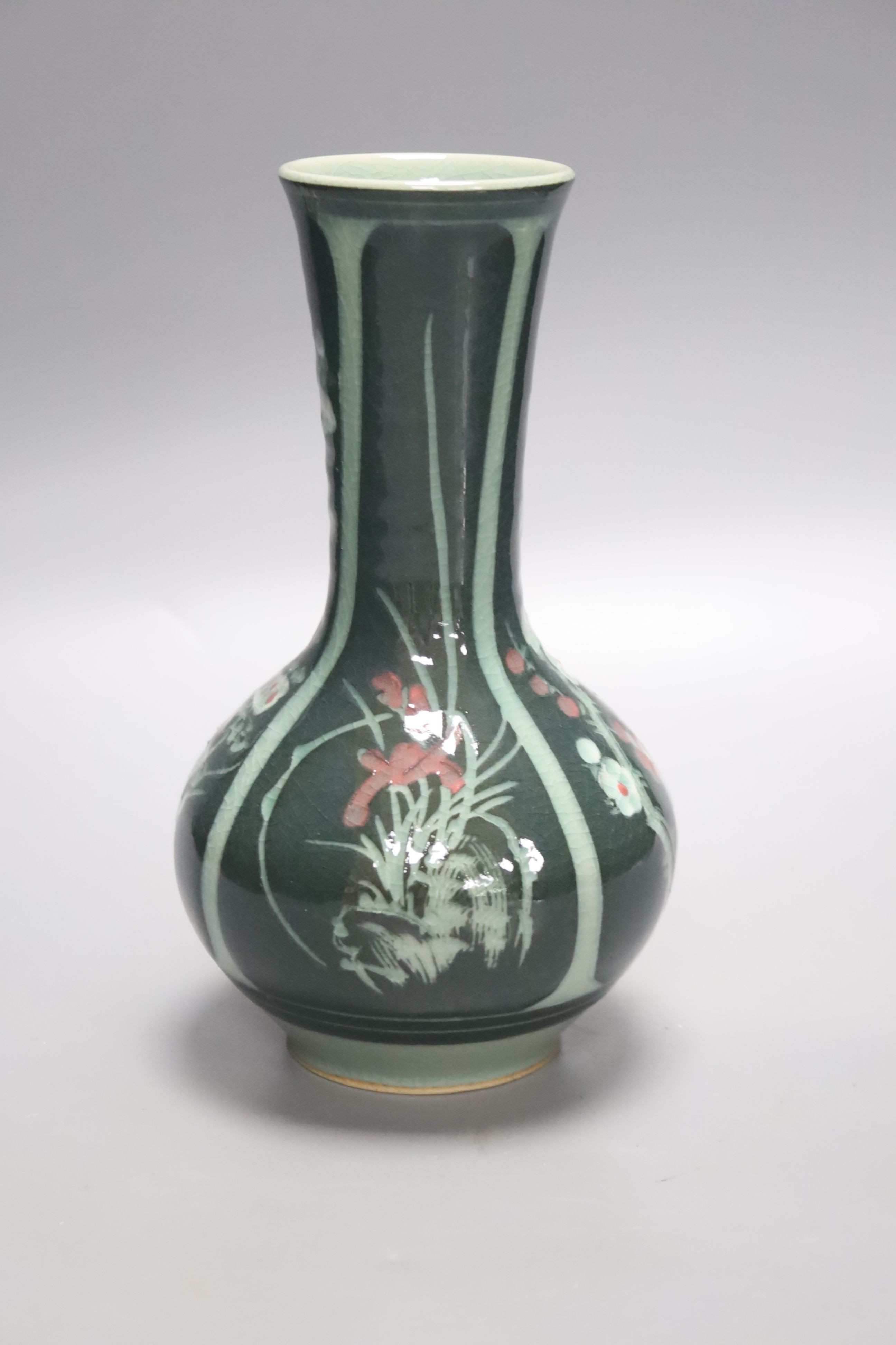 A green Japanese artisan studio vase decorated with flower designs, 20cm tall